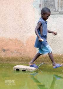 A child steps over stones to avoid ﬂooded streets just outside of Dakar, Senegal, where heavy rains caused severe ﬂooding. Source: Ricci Shryock/IFRC.