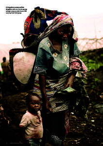 A Congolese woman and her daughter walk into the Mungunga refugee camp outside Goma, DRC carrying their belongings.  20