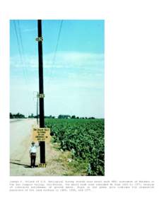 Joseph F. Poland of U.S. Geological Survey stands near bench mark S661 southwest of Mendota in the San Joaquin Valley, California. The bench mark site subsided 9m from 1925 to 1977, because of intensive withdrawal of gro