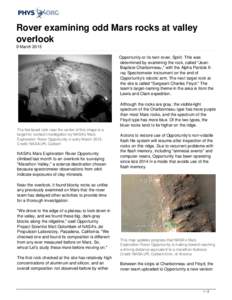 Rover examining odd Mars rocks at valley overlook