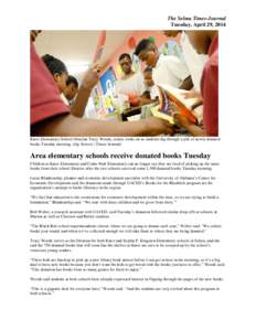 The Selma Times-Journal Tuesday, April 29, 2014 Knox Elementary School librarian Tracy Woods, center, looks on as students dig through a pile of newly donated books Tuesday morning. (Jay Sowers | Times-Journal)