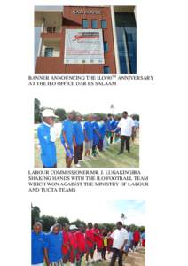 BANNER ANNOUNCING THE ILO 90TH ANNIVERSARY AT THE ILO OFFICE DAR ES SALAAM LABOUR COMMISSIONER MR. J. LUGAKINGIRA SHAKING HANDS WITH THE ILO FOOTBALL TEAM WHICH WON AGAINST THE MINISTRY OF LABOUR