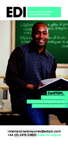 Teacher sitting on desk with text book in school classroom