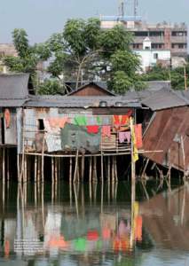 Slum houses in Dhaka, Bangladesh, raised above ground level to protect against ﬂooding. Source: Manoocher Deghati/IRIN.