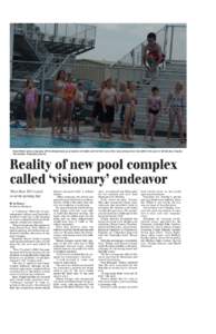 Ryan Moline takes a big jump off the diving board, as a long line of youths wait for their turns. They were among more than 200 in the pool on its first day of operation Sunday. (Republican photo)  Reality of new pool co