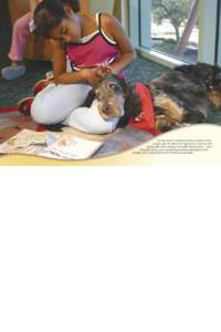The Main Library’s Reading Education Assistance Dogs program gave 80 children the opportunity to improve their reading skills with an audience of cuddly ‘listening dogs.’ “Dusty” the English Setter, one of seve